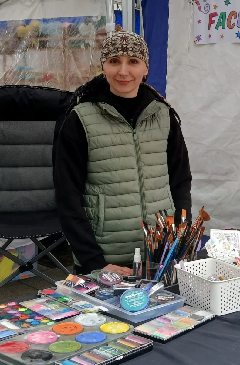 Irina at her face painting table with professional paints and brushes